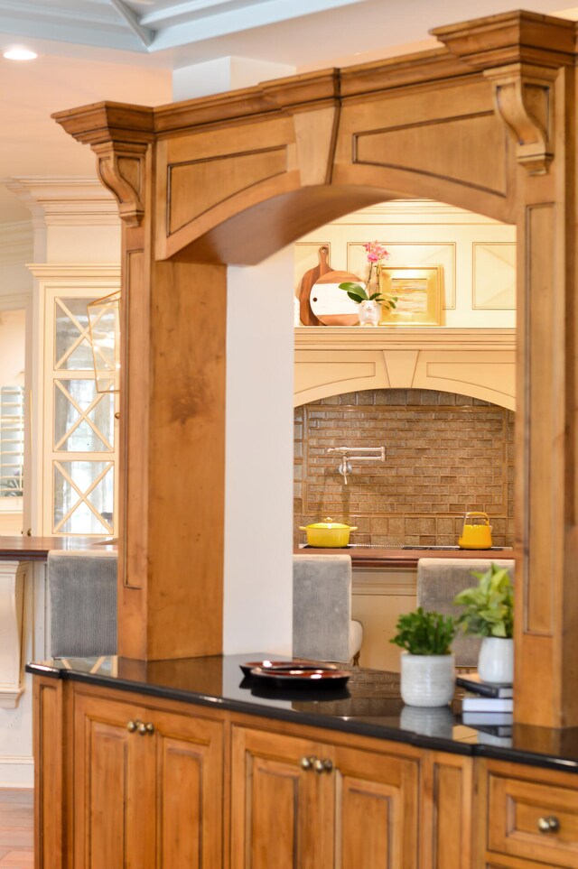 bar with ornamental molding, tasteful backsplash, and wood-type flooring