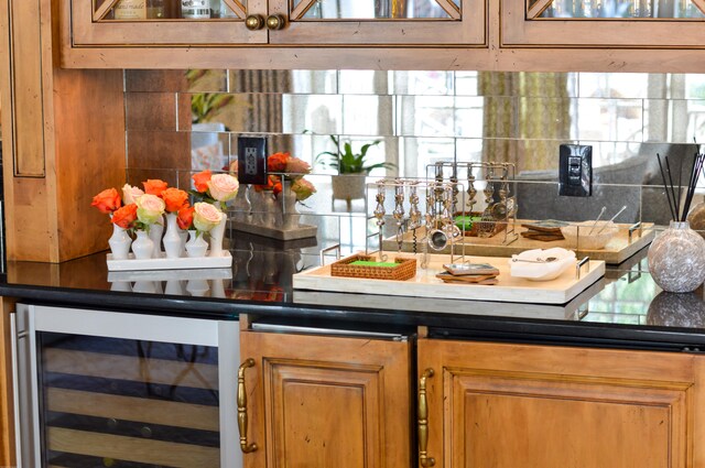 bar with backsplash and wine cooler