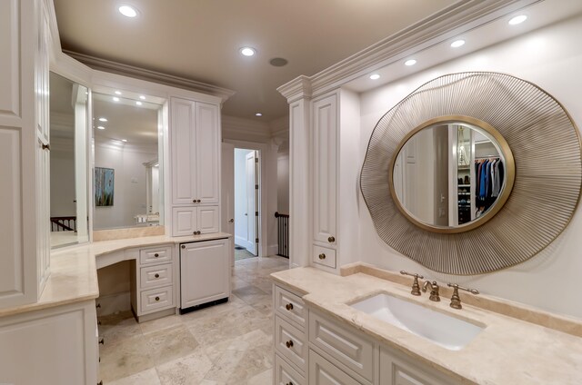 bathroom with tile flooring, ornamental molding, and vanity