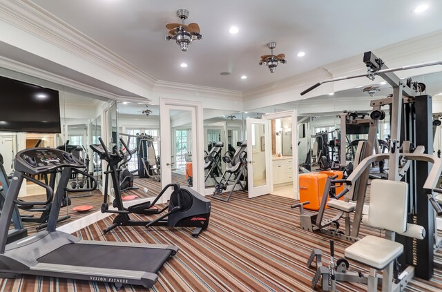 exercise room with carpet, ornamental molding, and ceiling fan