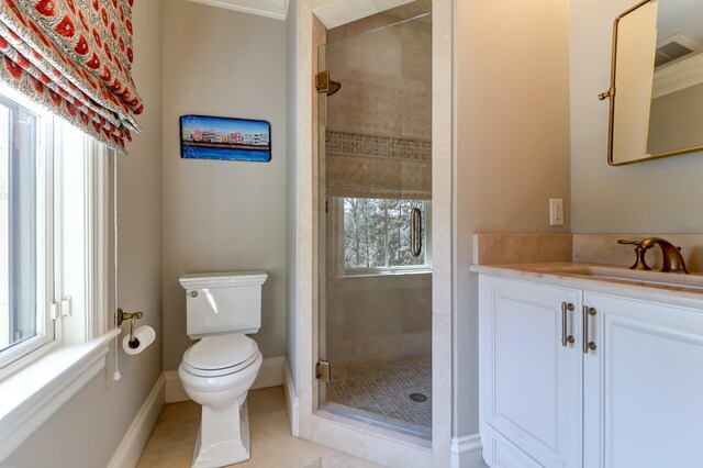 bathroom featuring toilet, vanity, crown molding, tile floors, and a tile shower