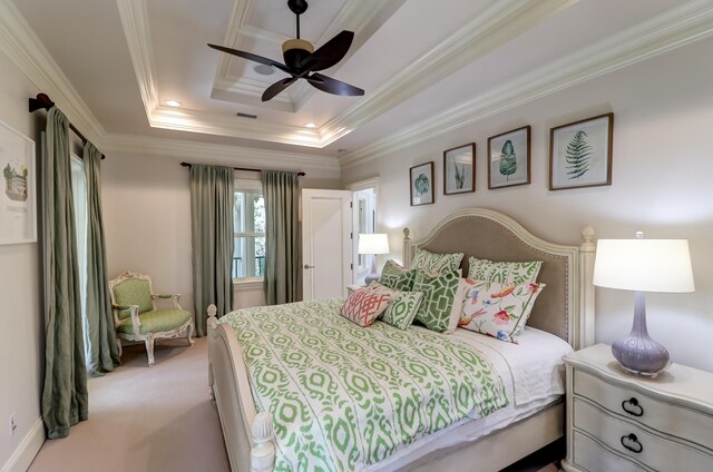 bedroom featuring crown molding, carpet floors, ceiling fan, and a tray ceiling