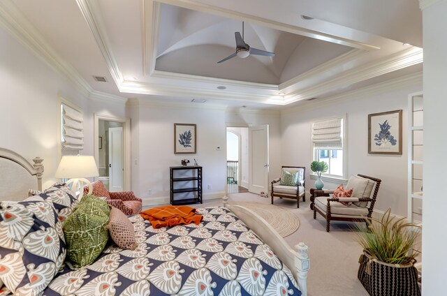 bedroom with ornamental molding, ceiling fan, a tray ceiling, and carpet