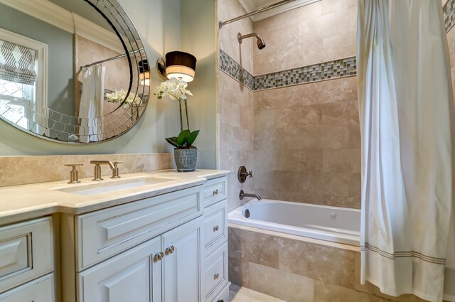 bathroom with ornamental molding, vanity, and shower / bath combo with shower curtain