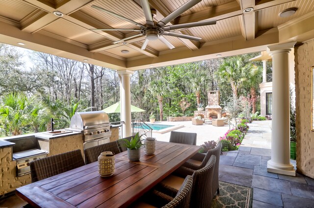 view of patio / terrace featuring an outdoor fireplace, area for grilling, and ceiling fan