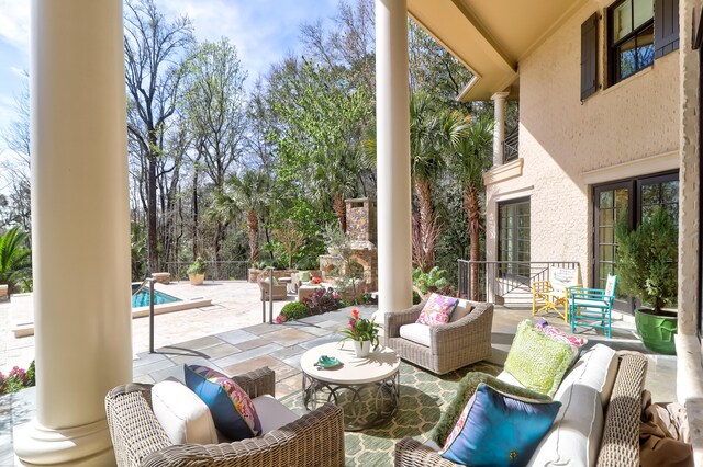 view of patio with outdoor lounge area and a fenced in pool