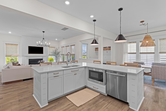1828 Agate Bay Dr, Mount Pleasant, SC 29466 - kitchen featuring stainless steel dishwasher, a sink, built in microwave, open floor plan, and recessed lighting