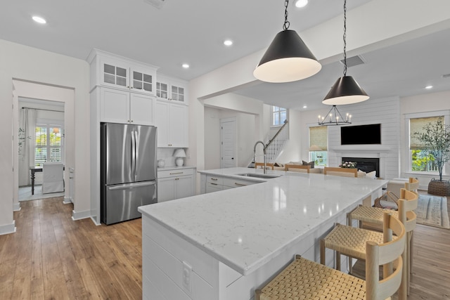 1828 Agate Bay Dr, Mount Pleasant, SC 29466 - kitchen with stainless steel fridge, a sink, light wood finished floors, a large island with sink, and white cabinetry