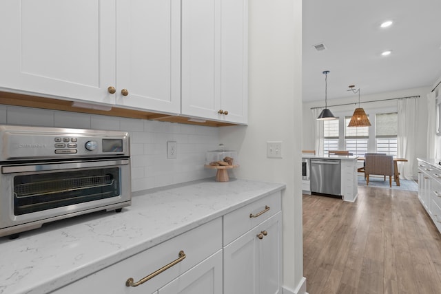 1828 Agate Bay Dr, Mount Pleasant, SC 29466 - kitchen with dishwasher, white cabinets, decorative backsplash, light stone counters, and recessed lighting