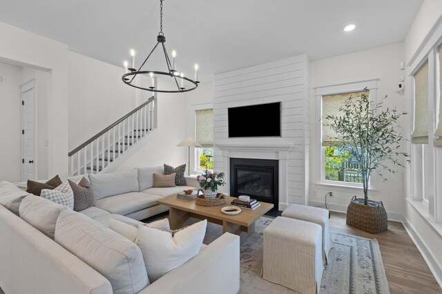 1828 Agate Bay Dr, Mount Pleasant, SC 29466 - living area with wood finished floors, stairway, a chandelier, a fireplace, and recessed lighting