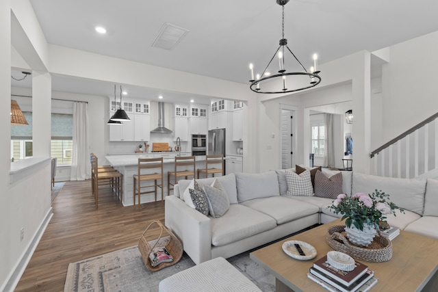 1828 Agate Bay Dr, Mount Pleasant, SC 29466 - living area featuring a chandelier, dark wood-type flooring, baseboards, recessed lighting, and stairway
