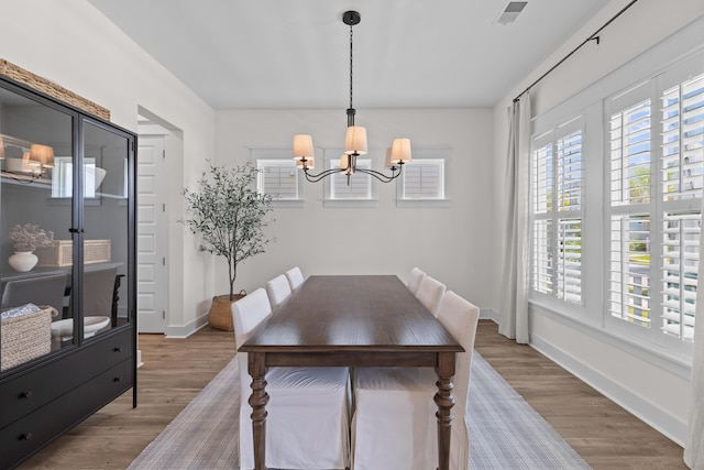 1828 Agate Bay Dr, Mount Pleasant, SC 29466 - dining space featuring a chandelier, wood finished floors, and baseboards