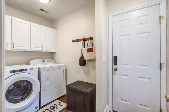 2916 Shadow Ln, North Charleston, SC 29406 - laundry area featuring cabinet space, washing machine and dryer, and dark wood-type flooring