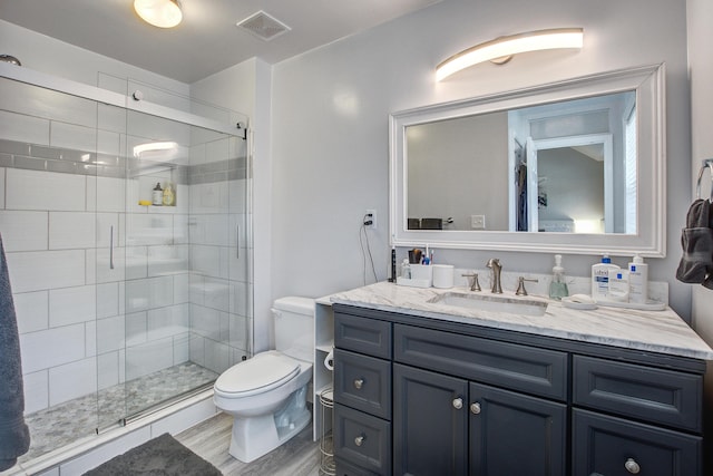2916 Shadow Ln, North Charleston, SC 29406 - full bath featuring vanity, toilet, a shower stall, and wood finished floors