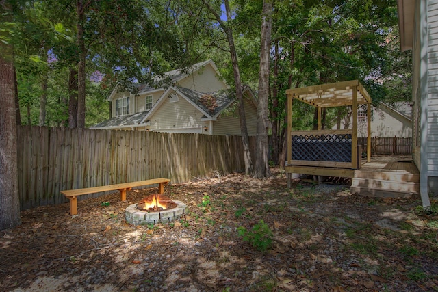 2916 Shadow Ln, North Charleston, SC 29406 - fenced backyard with a fire pit, a deck, and a pergola