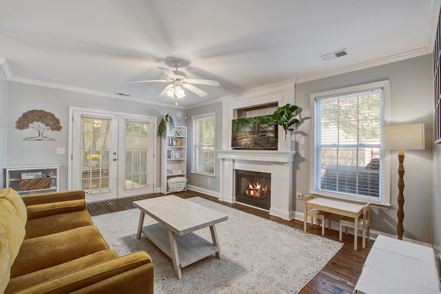 2916 Shadow Ln, North Charleston, SC 29406 - living room featuring french doors, ornamental molding, dark wood-style floors, a fireplace, and a ceiling fan