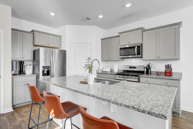 kitchen featuring appliances with stainless steel finishes, gray cabinets, and dark wood finished floors