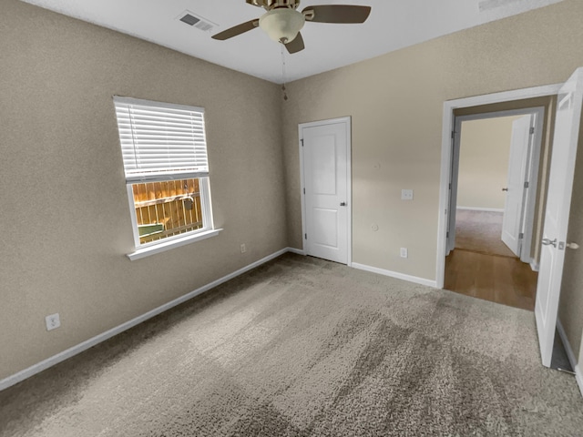 unfurnished bedroom featuring visible vents, baseboards, carpet, and ceiling fan