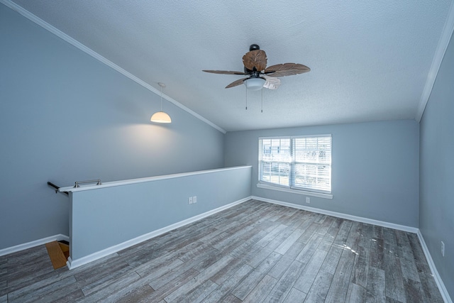 spare room with lofted ceiling, dark hardwood / wood-style floors, a textured ceiling, and ceiling fan