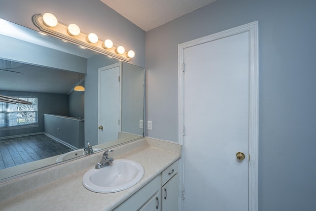 bathroom with vanity and a textured ceiling