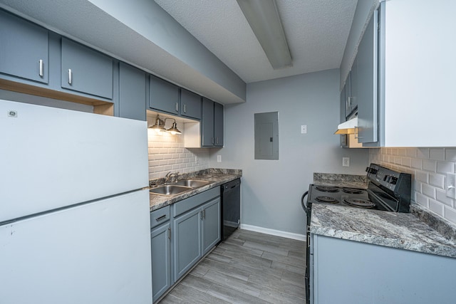 kitchen featuring tasteful backsplash, sink, electric panel, light hardwood / wood-style floors, and black appliances