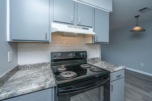 kitchen with pendant lighting, backsplash, dark hardwood / wood-style floors, light stone countertops, and black / electric stove