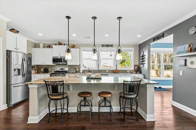 kitchen with a kitchen island, appliances with stainless steel finishes, and white cabinets