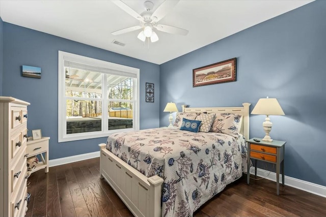 bedroom with dark hardwood / wood-style floors and ceiling fan