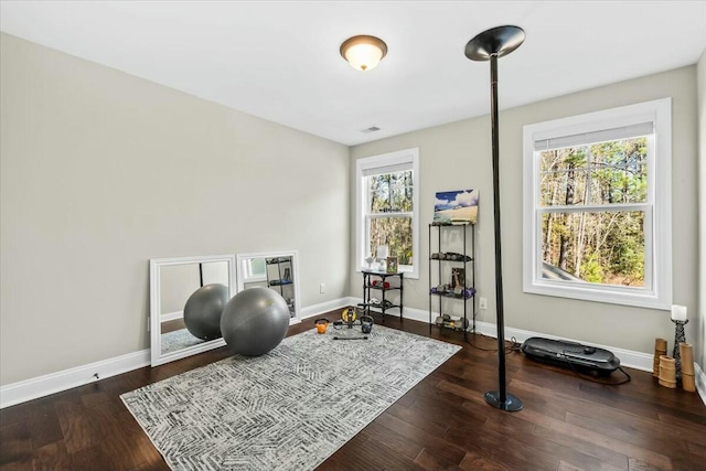 exercise room with dark hardwood / wood-style flooring