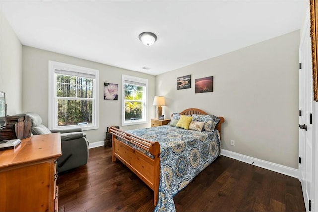 bedroom with dark wood-type flooring