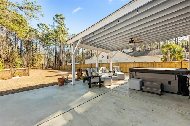 view of patio featuring outdoor lounge area, ceiling fan, and a hot tub