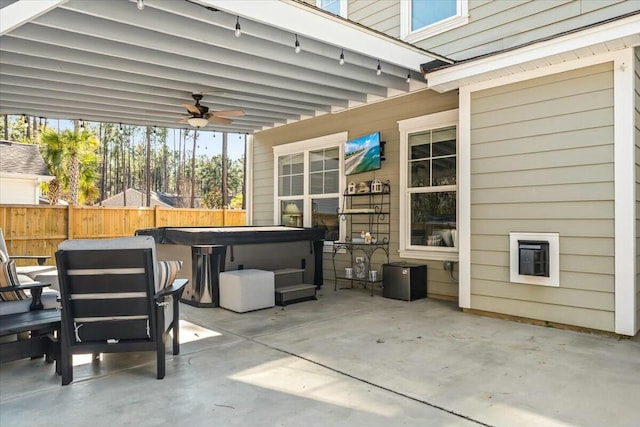 view of patio featuring a hot tub and ceiling fan