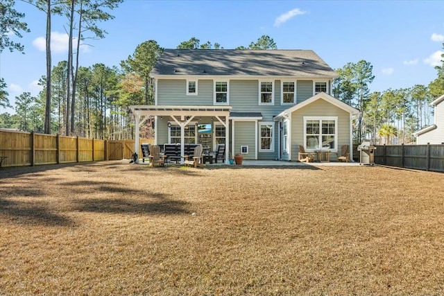 rear view of property with a yard and a patio area