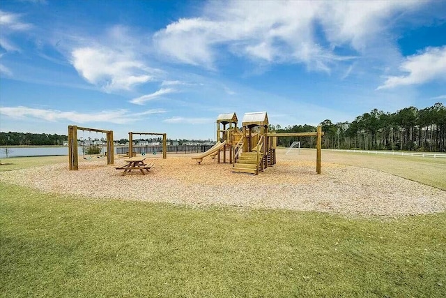 view of play area featuring a water view and a lawn