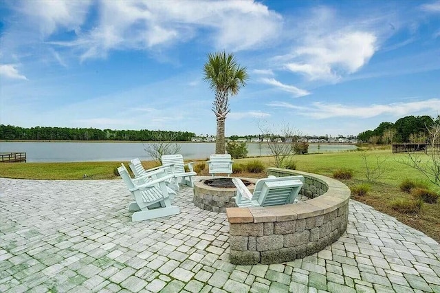 view of patio featuring a water view and an outdoor fire pit