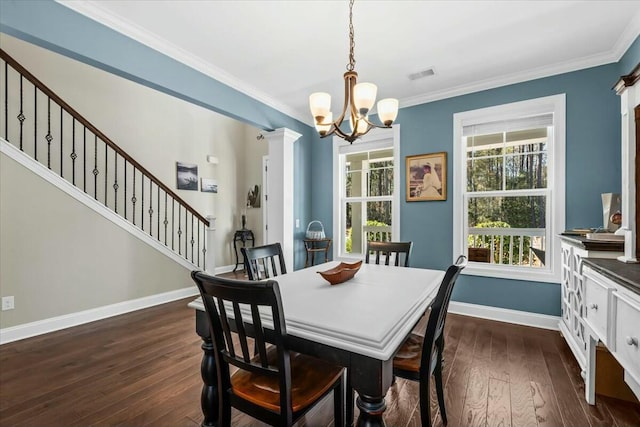 dining area featuring ornate columns, ornamental molding, dark hardwood / wood-style floors, and a chandelier