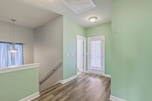 foyer with visible vents, dark wood finished floors, and baseboards