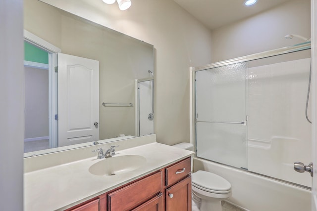 bathroom with toilet, shower / bath combination with glass door, and vanity