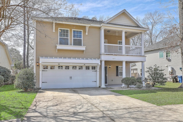 view of front facade featuring a balcony, driveway, a front lawn, and an attached garage