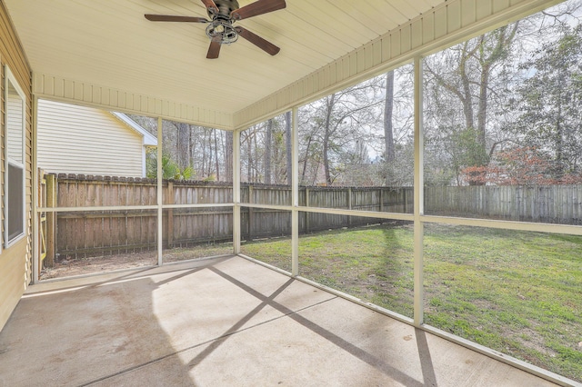 unfurnished sunroom featuring ceiling fan