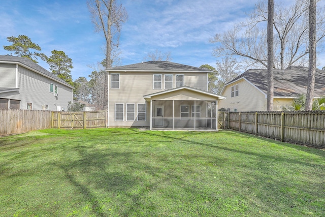 rear view of house with a sunroom, a fenced backyard, a gate, and a lawn