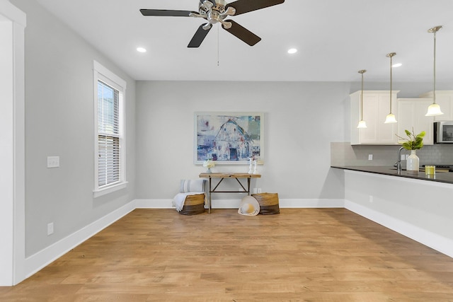 interior space with light hardwood / wood-style flooring and ceiling fan