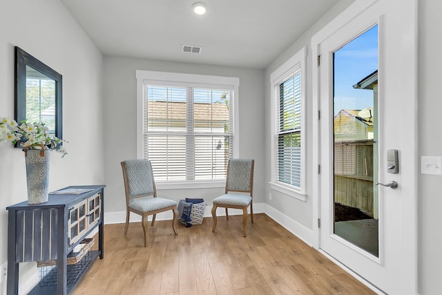 living area featuring a wealth of natural light and light hardwood / wood-style floors