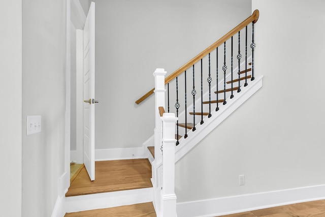 stairs with hardwood / wood-style flooring