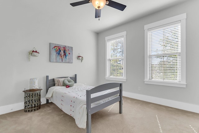 bedroom featuring ceiling fan and light carpet