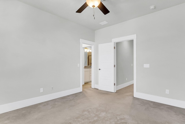 unfurnished bedroom featuring ensuite bathroom, light carpet, and ceiling fan