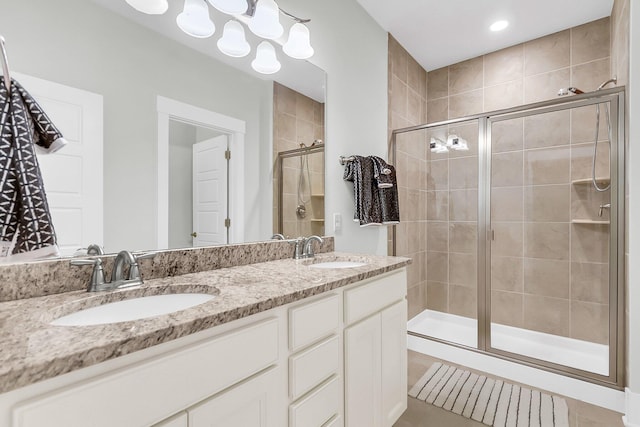 bathroom featuring vanity, tile patterned floors, and a shower with shower door