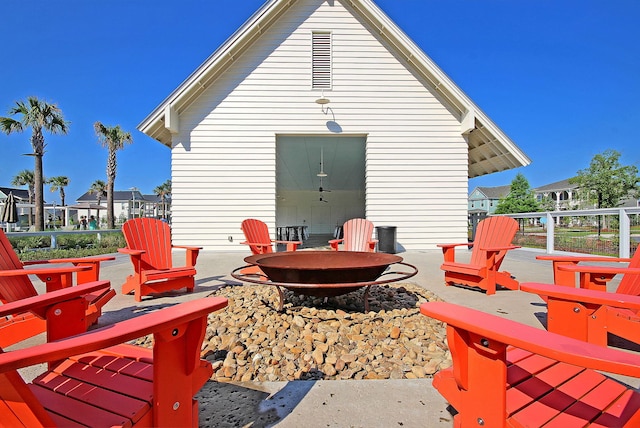 wooden terrace featuring a patio and an outdoor fire pit