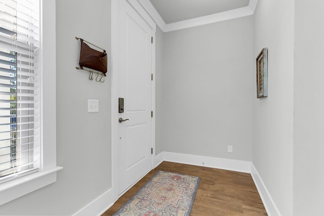 entryway with crown molding and hardwood / wood-style floors