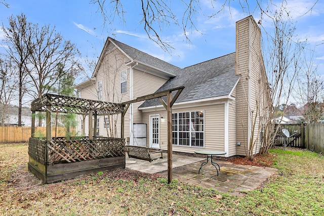 back of house featuring a patio, a fenced backyard, a chimney, roof with shingles, and a pergola